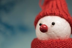 toy snowman with red cap and scarf