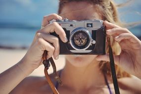 blonde girl taking camera and making photo