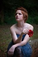 Girl is sitting outdoors