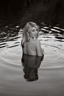 Black and white photo of the girl without clothes in the water