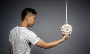 man holds a lamp in his hand