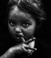 black and white portrait of a child with a finger in his mouth