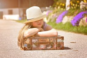 girl in hat with luggage