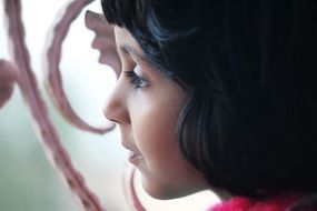 Portrait of the child looking out of the window