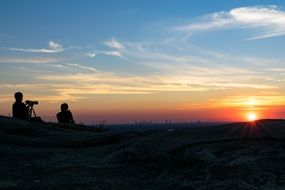 camera man makes sunset photos