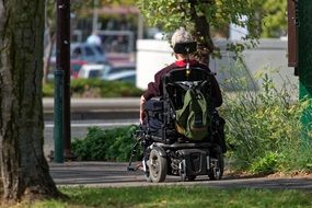 man in motorized invalid chair