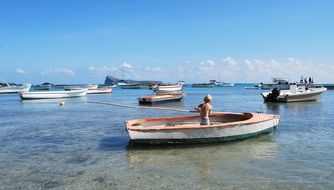 little child alone in a boat with an oar