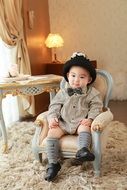 portrait of a sitting little boy among the beautiful furniture