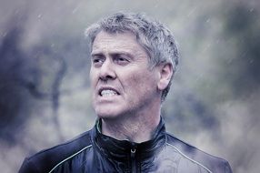 portrait of a strong man in the rain