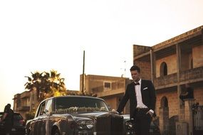 groom near the rolls-royce in the street