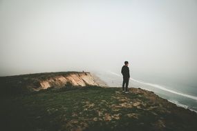 young man on the edge of a hill