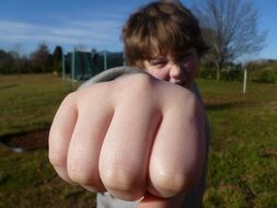 boy shows fist