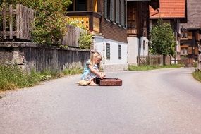 Child with school bag on the road in the village