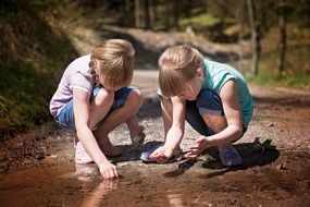 children girl explore nature puddle snails stones