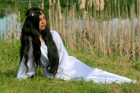 girl in a white dress with long hair near the water