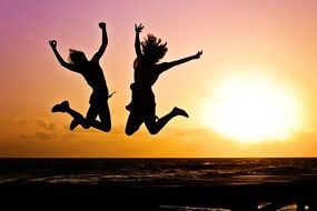 two happy people jump