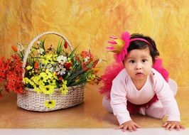 little princess near a basket with flowers