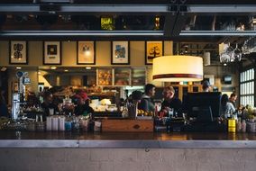 people are sitting at tables in a restaurant