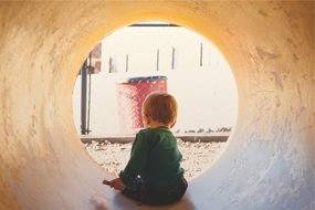 kid in tunnel playing