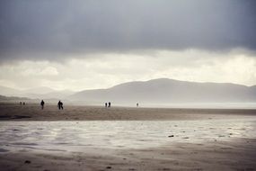 people on the ocean under rainy sky