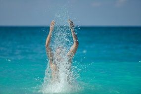 young man splashing in sea