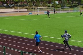 running athletes on stadium