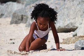 african girl playing in the sand, south africa