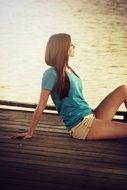 young girl sits on the ground