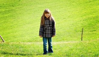 girl child with long hair in the meadow