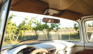 man and woman in rear-view mirror in a car