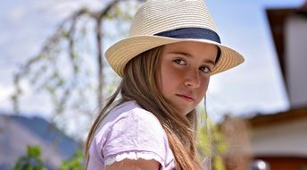 little girl with long hair in the hat