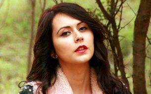 portrait of a girl with dark hair near a tree