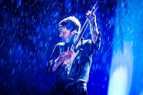 guitar player under the rain