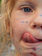 face of a little girl with paint