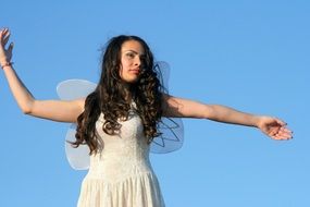 fairy girl in a white angel costume with wings