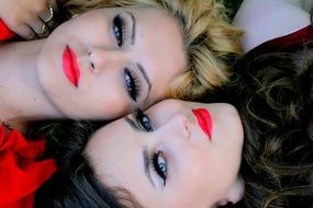 beauty of two green-eyed girls with red lips