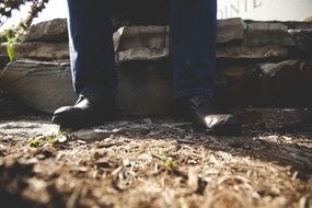 man feet in jeans and shoes