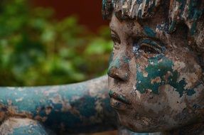 profile of a boy face as an old statue close up