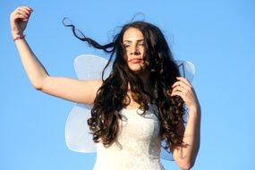 girl in a dress with wings demonstrating of the fairy