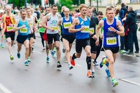 athletes in t-shirts with snomaras at a marathon