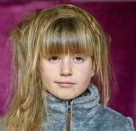 girl with disheveled hair and a smile on her face