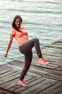 Photo of woman doing sports on a sea bank