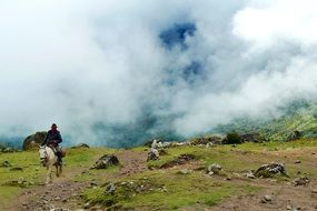 a man riding a horse on the background of the highlands of Argentina