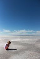 lonely child in desert salt flat landscape