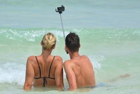 couple doing selfie in the sea
