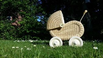 White baby carriage on a grass
