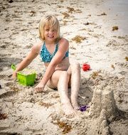 a girl is building a sand castle