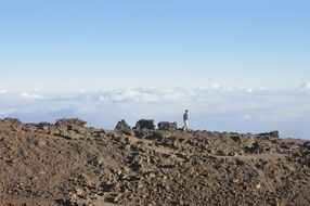 man walks on top of a mountain
