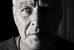 black and white portrait of a man with half face visibility
