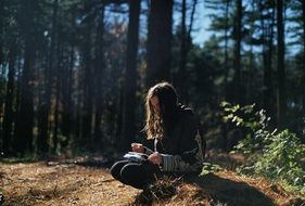 girl reading in the forest